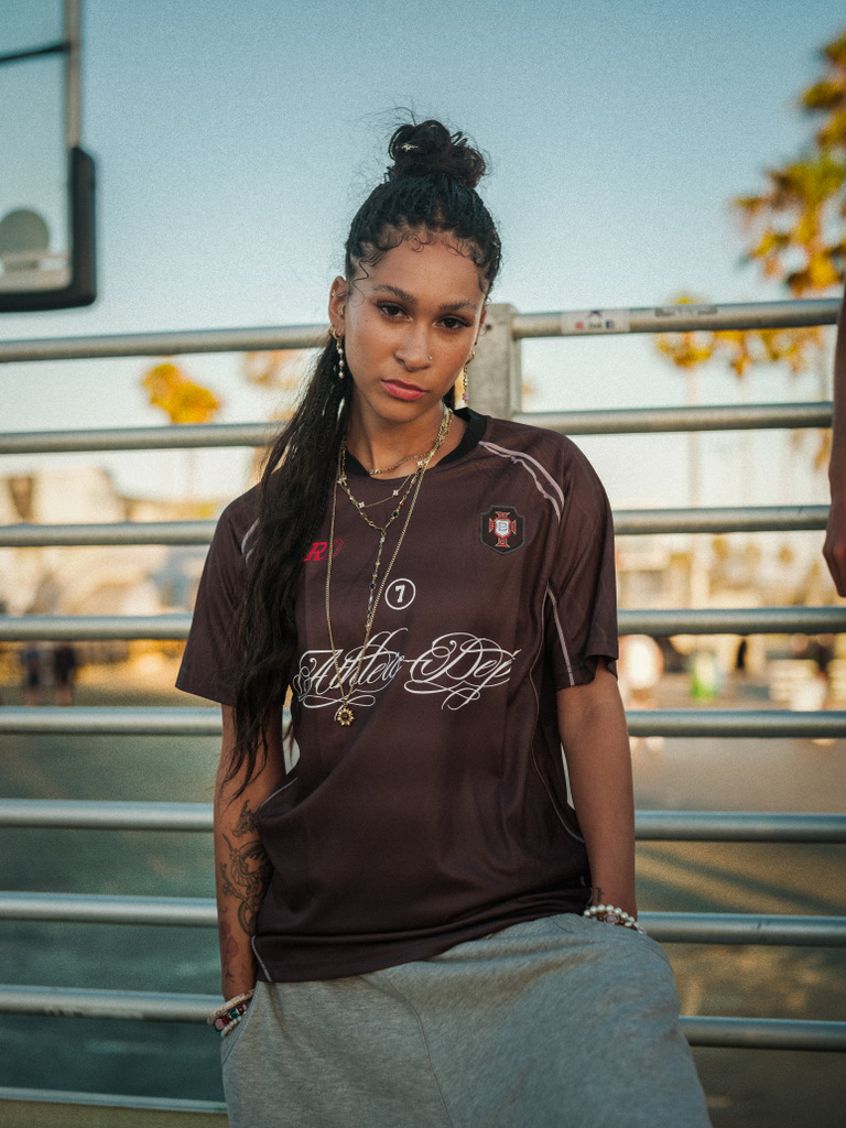 Maria Williams in a BLRD jersey at golden hour by the beach