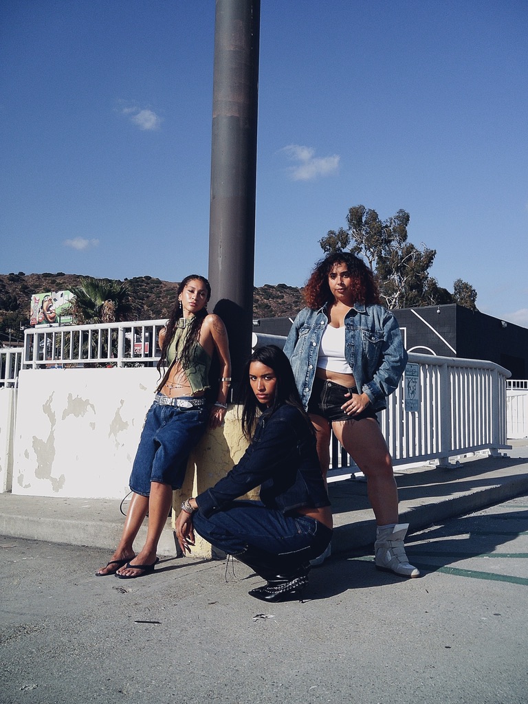 Maria Williams and two models in Gap denim against a hillside skyline